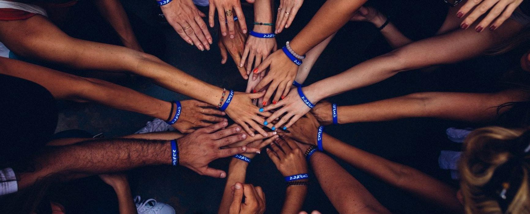 Hands coming together in a circle